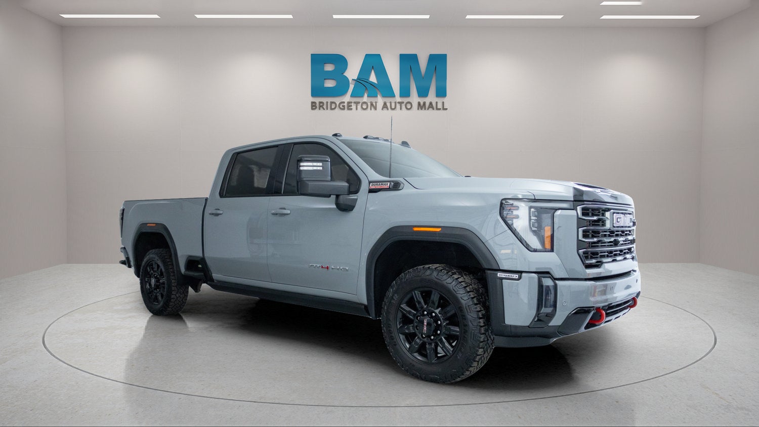 2024 GMC Sierra 2500 HD AT4 in Thunderstorm Gray — front three-quarter view